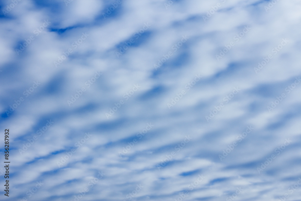 sky with layered cumulus clouds. blue background with unusual cloud texture sky with layered cumulus clouds. blue background with unusual cloud texture