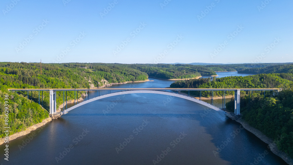 The Zdakov Bridge in the Czech Republic is a modern arch bridge over the Vltava River, offering a clear view of the surrounding countryside. The Zdakov Bridge in the Czech Republic is a modern arch bridge over the Vltava River, offering a clear view of the surrounding countryside.