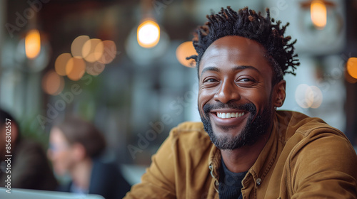 portrait of A mature African-American man happily working remotely in a public place.