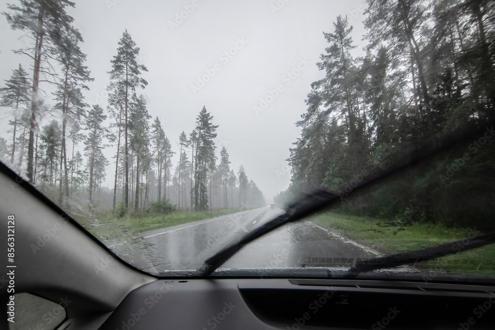 Car window driving on the road during rain, looking from inside the car to outside. Storm Lithuania 2024 Car window driving on the road during rain, looking from inside the car to outside. Storm Lithuania 2024