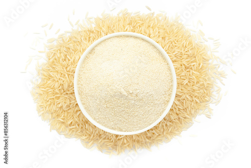 A bowl of Organic Rice (Oryza sativa) Flour, placed over a heap of Rice. Isolated on a white background. photo