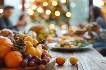 Thanksgiving family vegan lunch, with autumn decoration and plenty of healthy food on the table, with blurred happy people around the table celebrating the holiday.