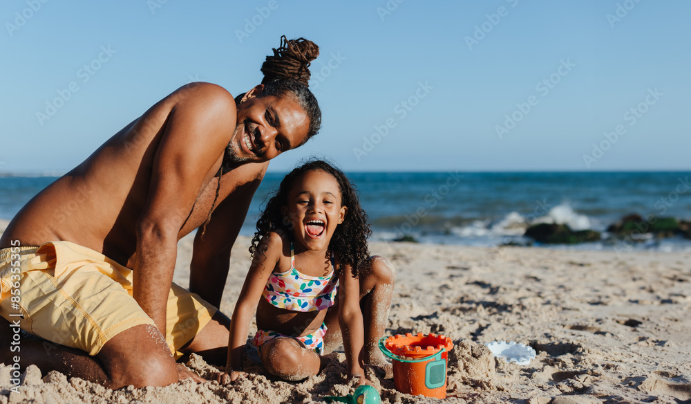 Happy father and daughter enjoying a sunny beach vacation together Happy father and daughter enjoying a sunny beach vacation together
