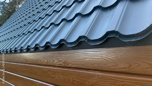 Metal roof, building materials, iron lining imitation of wooden beams.