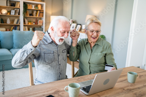 Senior couple husband and wife hold credit card online shopping