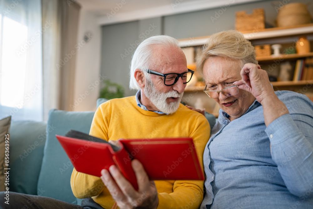 Senior couple man and woman husband wife looking family photos album Senior couple man and woman husband wife looking family photos album