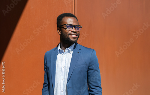 Smiling African American businessman in blue suit outdoors