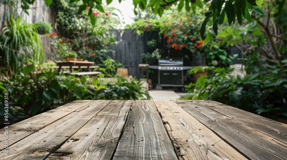 Empty Space on an Aged Wooden Table with a Garden and Grill in the Background Empty Space on an Aged Wooden Table with a Garden and Grill in the Background