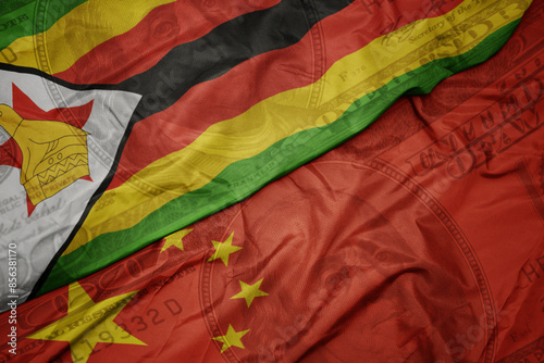 Photography waving colorful flag of zimbabwe and national flag of china on the dollar money background