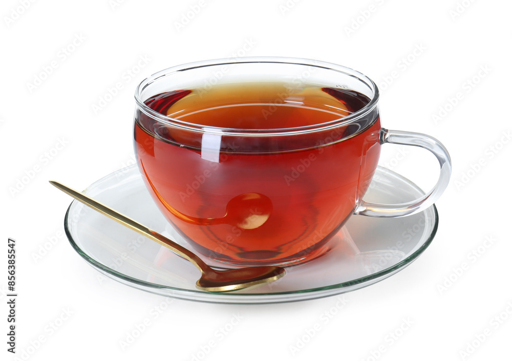 Aromatic tea in glass cup and golden spoon isolated on white Aromatic tea in glass cup and golden spoon isolated on white