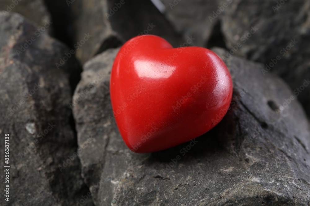 One red decorative heart on stones, closeup One red decorative heart on stones, closeup