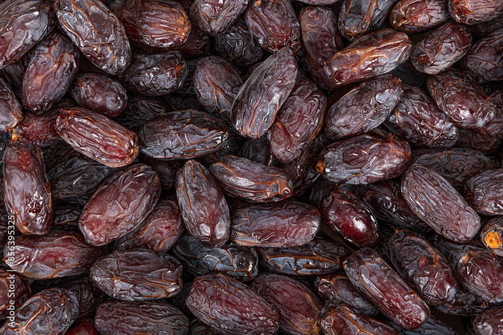 Full frame background top view of pile of appetizing dried date medjoul fruits arranged on surface Full frame background top view of pile of appetizing dried date medjoul fruits arranged on surface