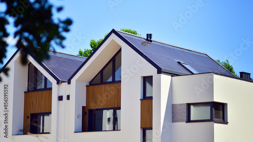 Fototapeta Naklejka Na Ścianę i Meble -  Terraced family homes in newly developed housing estate. The real estate market in the suburbs. New single family houses in a new development area. Residential homes with modern facade. 