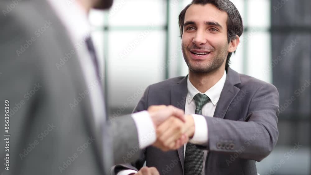 Portrait of cheerful young manager handshake with new employee. Portrait of cheerful young manager handshake with new employee.
