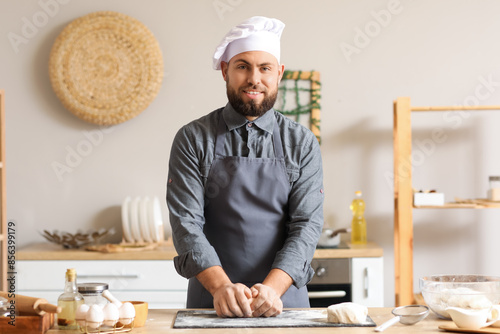 Male baker preparing dough ...