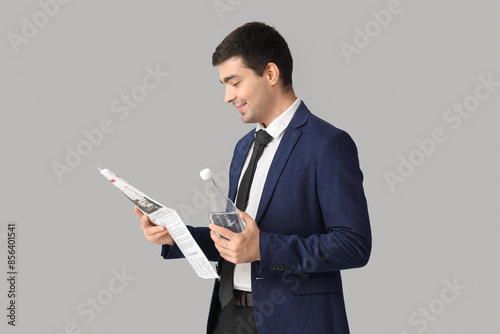 Young businessman with bott...