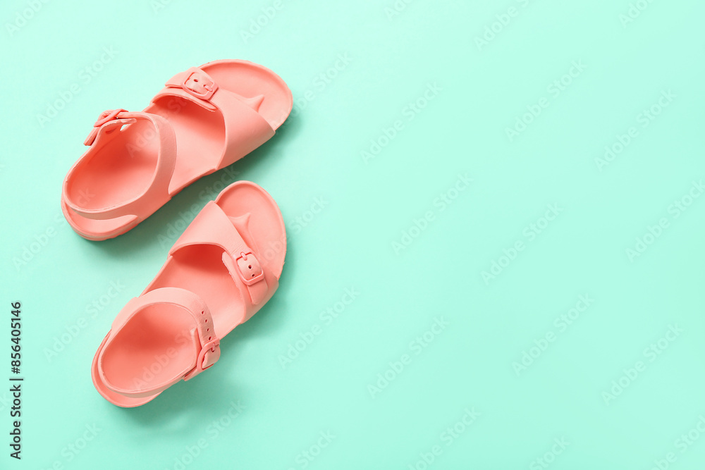 Pair of stylish child's sandals on color background Pair of stylish child's sandals on color background