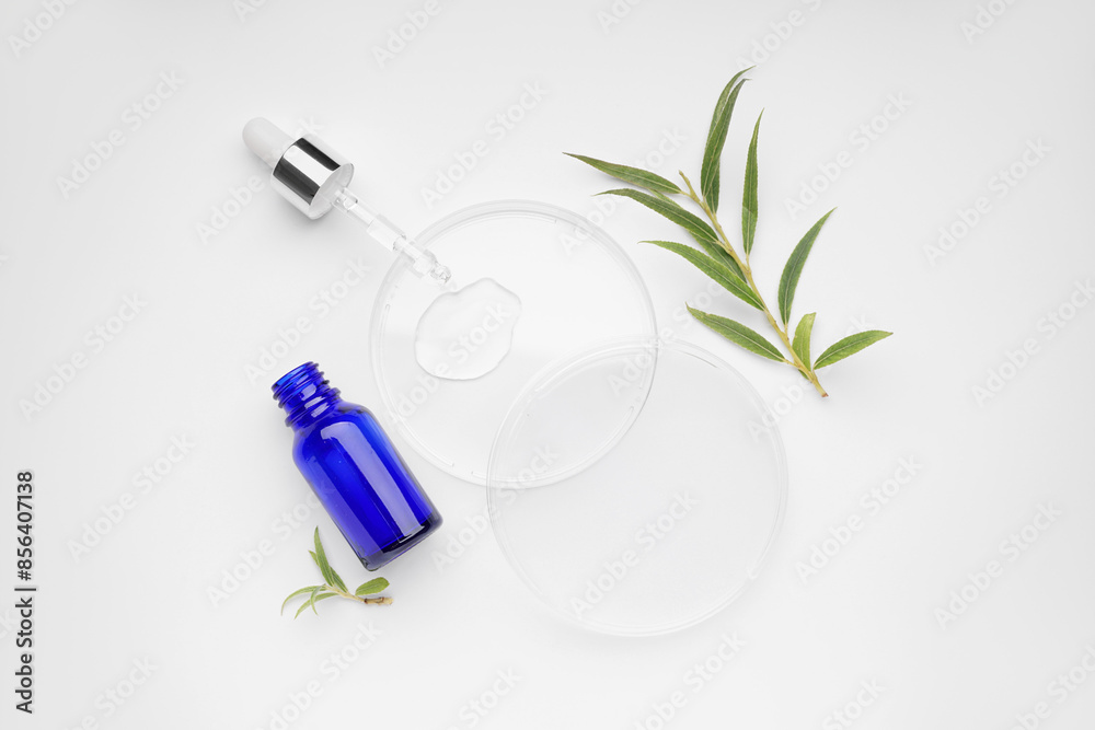 Petri dishes with plant leaves and bottle of cosmetic product on white background Petri dishes with plant leaves and bottle of cosmetic product on white background