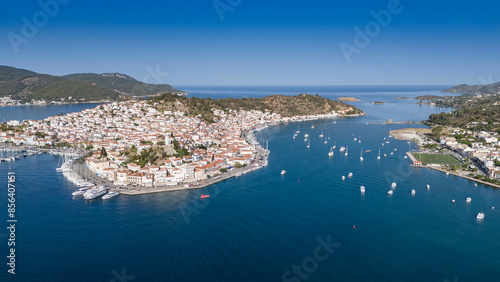 Aerial panorama of the city and harbor of Poros island in the Saronic Gulf, Greece, during a colorful summer sunset