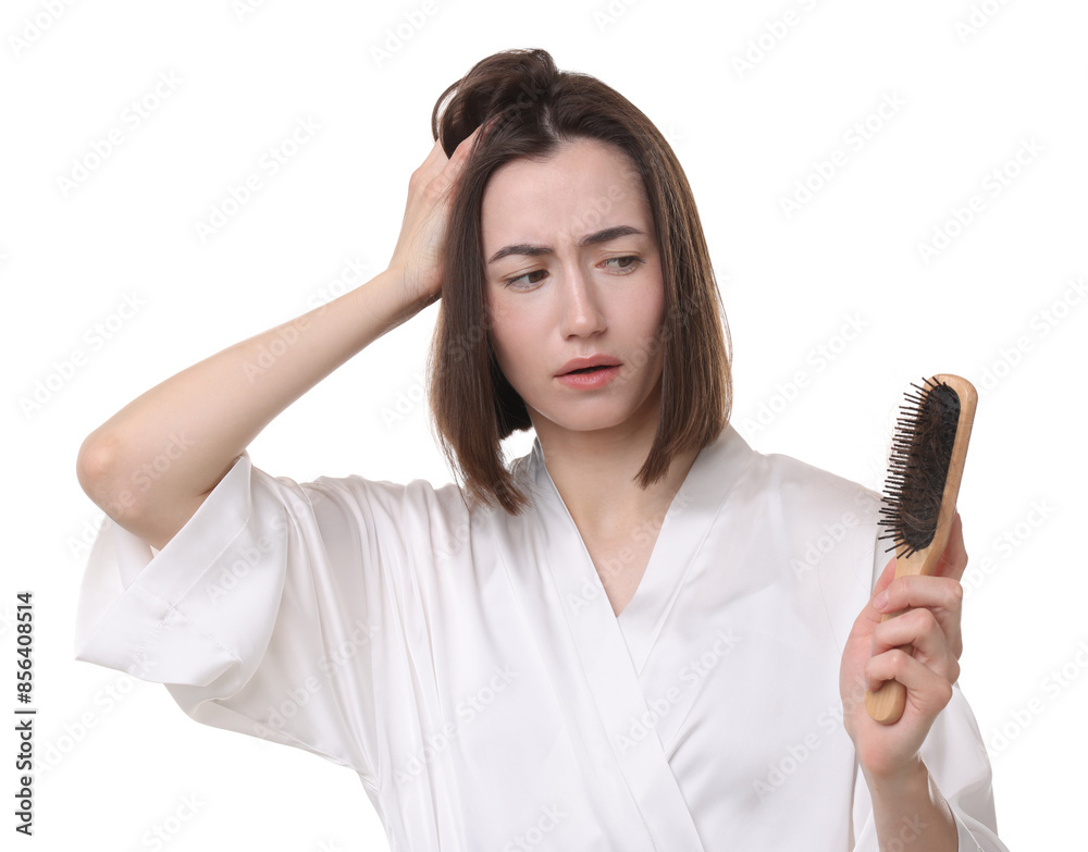 Stressed woman holding brush with lost hair on white background. Alopecia problem