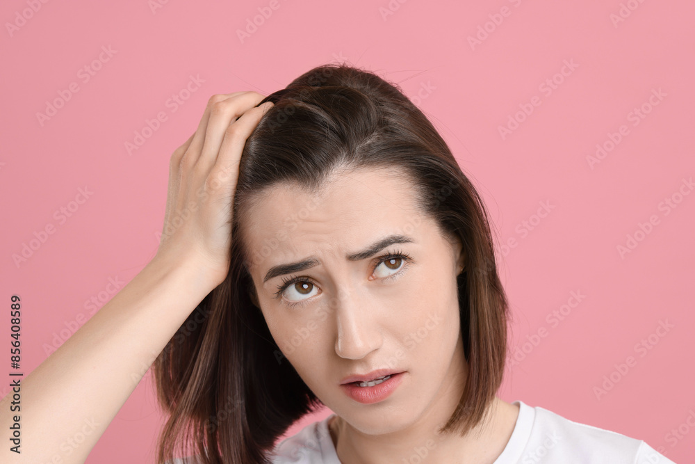 Fototapeta premium Sad woman with hair loss problem on pink background, closeup