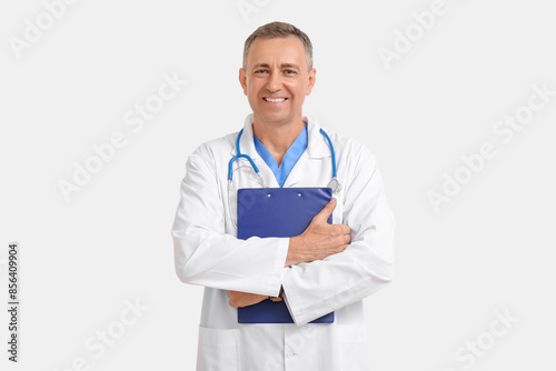 Mature doctor with clipboar...