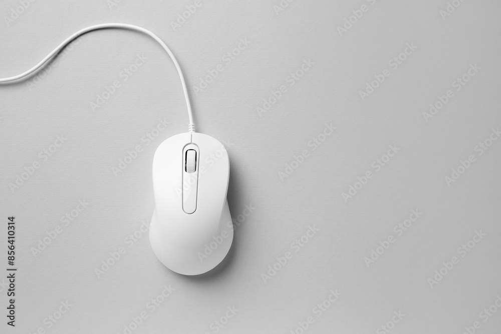One wired mouse on grey background, top view. Space for text One wired mouse on grey background, top view. Space for text