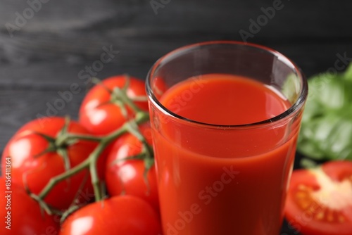 Fresh tomato juice in glass on table, closeup