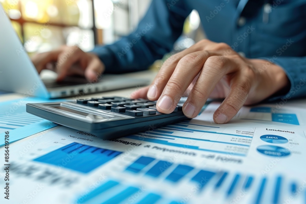 A person is using a calculator to add numbers on a piece of paper. A person is using a calculator to add numbers on a piece of paper.