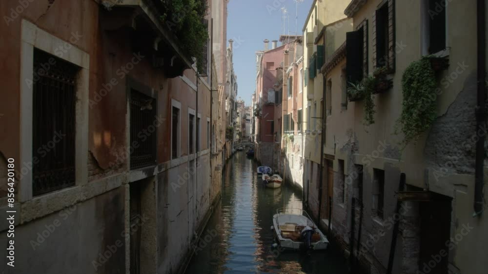 Narrow canals in Venice, Italy while crossing a bridge Narrow canals in Venice, Italy while crossing a bridge