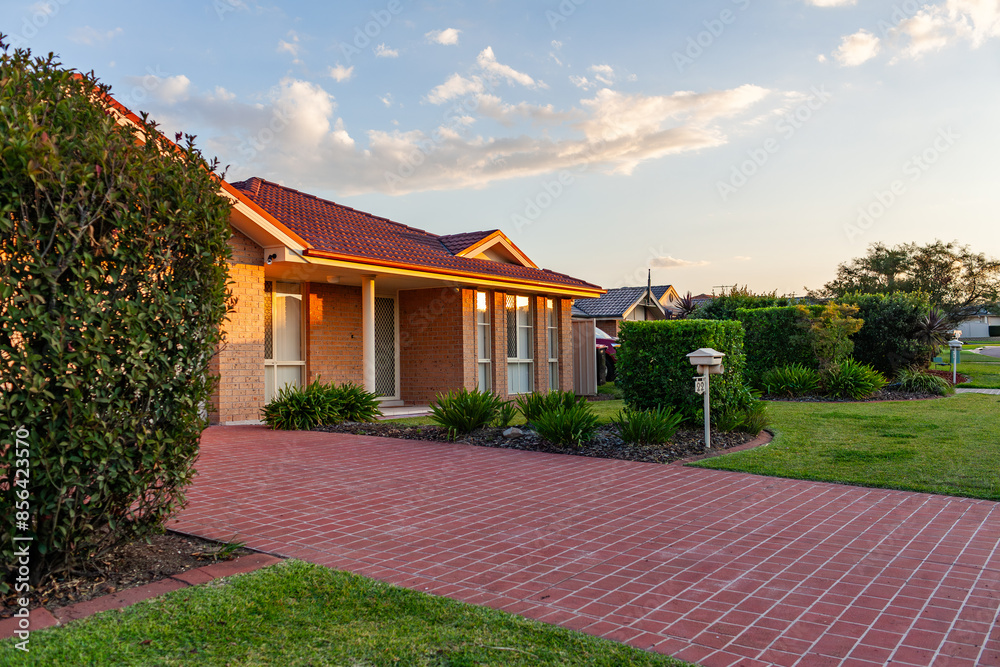 Last sunset light on brick house in quiet suburban area Last sunset light on brick house in quiet suburban area