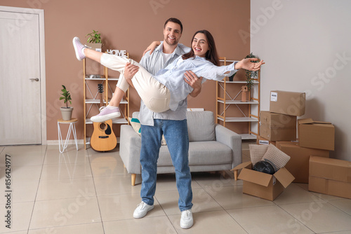 Happy young couple in room ...