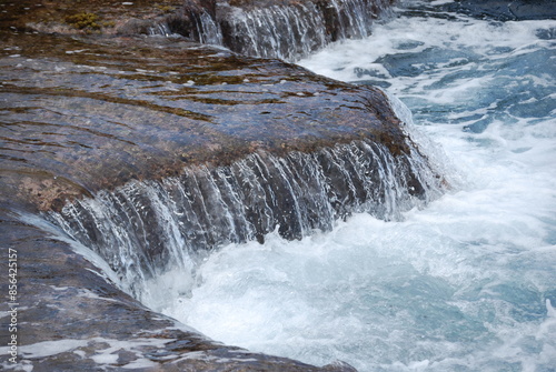 water flowing over rocks into the ocean