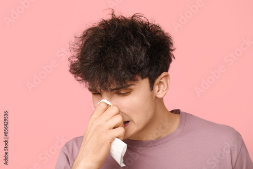 Young man with runny nose o...