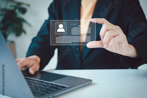 Digital identification or digital ID concept. Businesswoman use laptop and hand touch virtual screen of digital identification card to accessing databases by digital identity for cyber security.