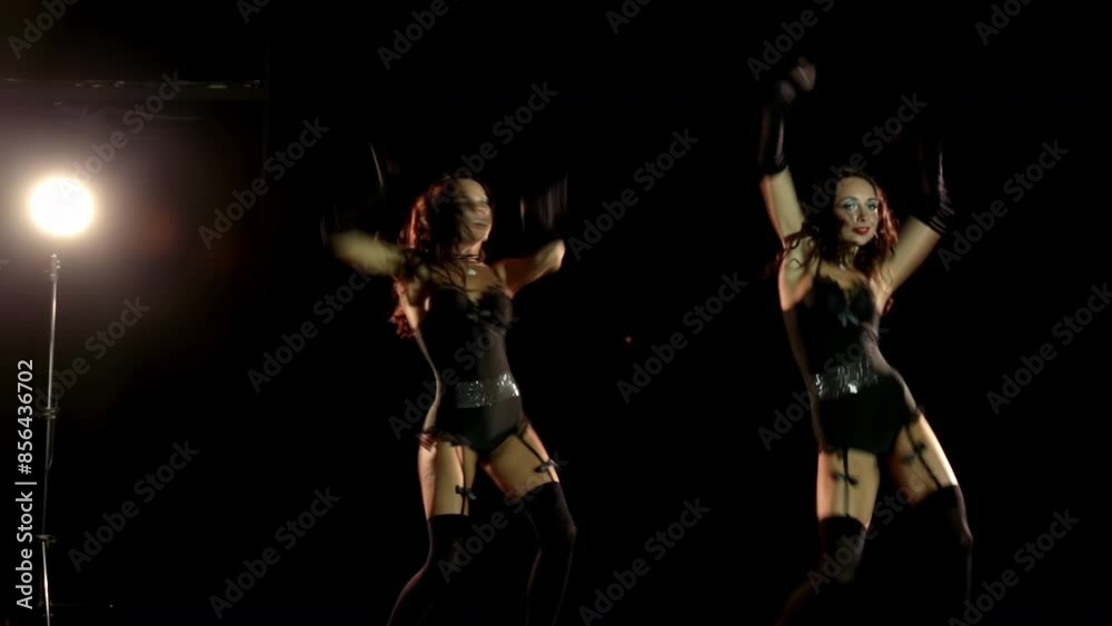 Dancing girls in stockings on black background Dancing girls in stockings on black background