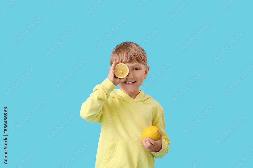 Cute little boy with lemon on blue background Cute little boy with lemon on blue background