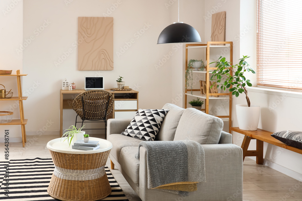 © Pixel-Shot - Interior of stylish living room with grey sofa, coffee table, workplace and shelving unit