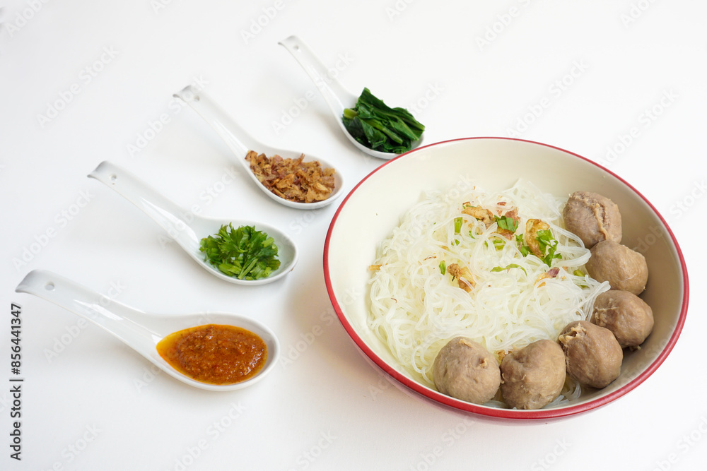 Bakso Meatballs and Rice Noodles with Soup Served Chili Sauce, Indonesia Food Style Popular Street Food served on bowl with chili sauce, chopped celery and fried onions sideview Bakso Meatballs and Rice Noodles with Soup Served Chili Sauce, Indonesia Food Style Popular Street Food served on bowl with chili sauce, chopped celery and fried onions sideview