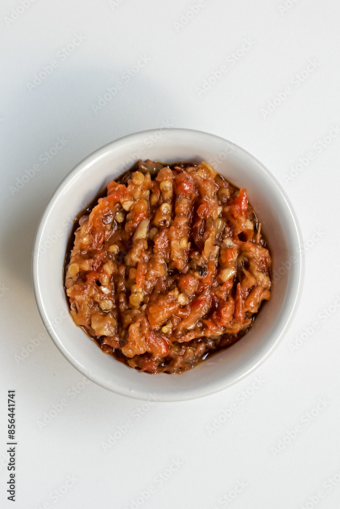 Indonesia traditional cuisine sambal bawang or spicy garlic chili sauce served on a white bowl isolated on white background. Indonesia traditional cuisine sambal bawang or spicy garlic chili sauce served on a white bowl isolated on white background.