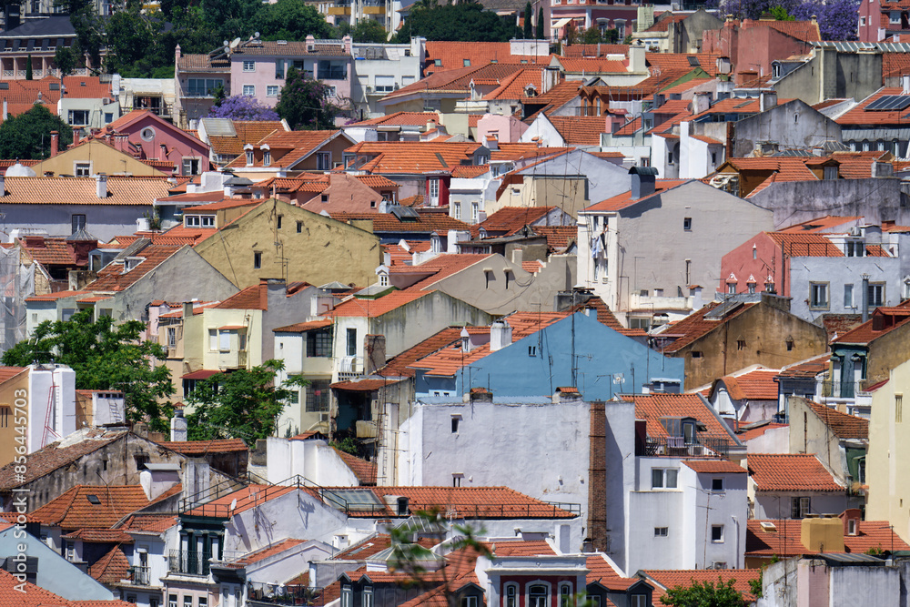 aerial view of the white and pastel-colored old buildings with red-tiled roofs in the charming, winding old town of lisbon aerial view of the white and pastel-colored old buildings with red-tiled roofs in the charming, winding old town of lisbon