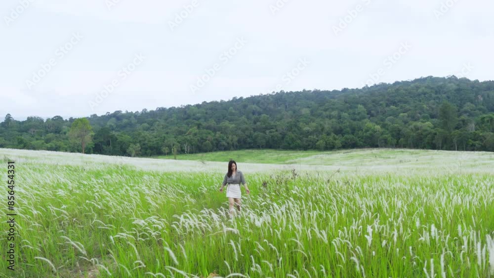 Asian woman who is lonely. In the grass, she is happy. Asian woman who is lonely. In the grass, she is happy.