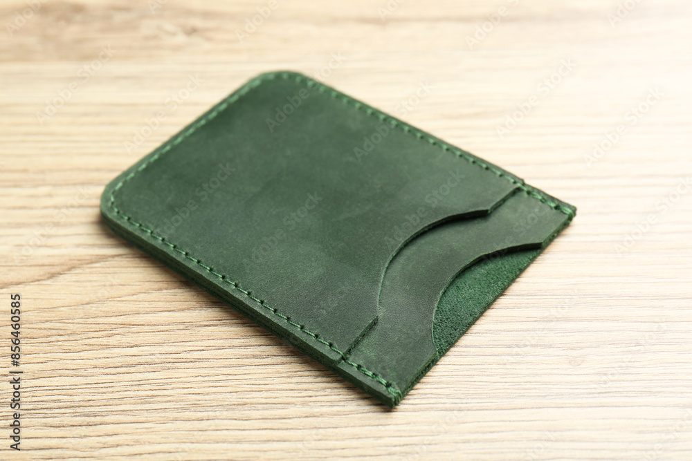 Leather business card holder on wooden table, closeup Leather business card holder on wooden table, closeup