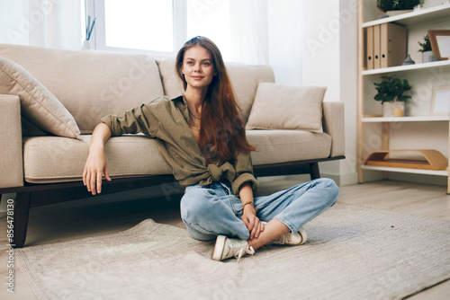 Relaxing in a Cozy Apartment: A Happy Woman Enjoying Modern Comfort on her Sofa
