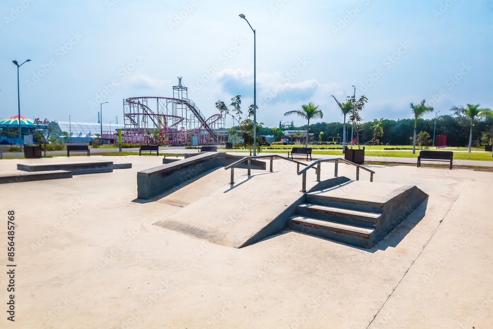 Skatepark in tampico on sunny day with amusement park in the background Skatepark in tampico on sunny day with amusement park in the background