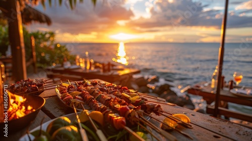 A shot of the sunset over the ocean with a group of food critics dining at a romantic outdoor restaurant. They are served a variety of skewered meats and vegetables grilled to perfection