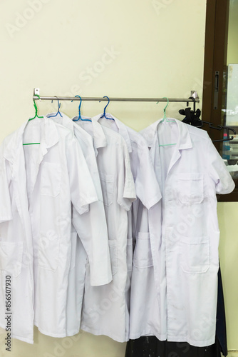 Wallpaper Mural White medical gowns hang on hangers in the hospital. Torontodigital.ca