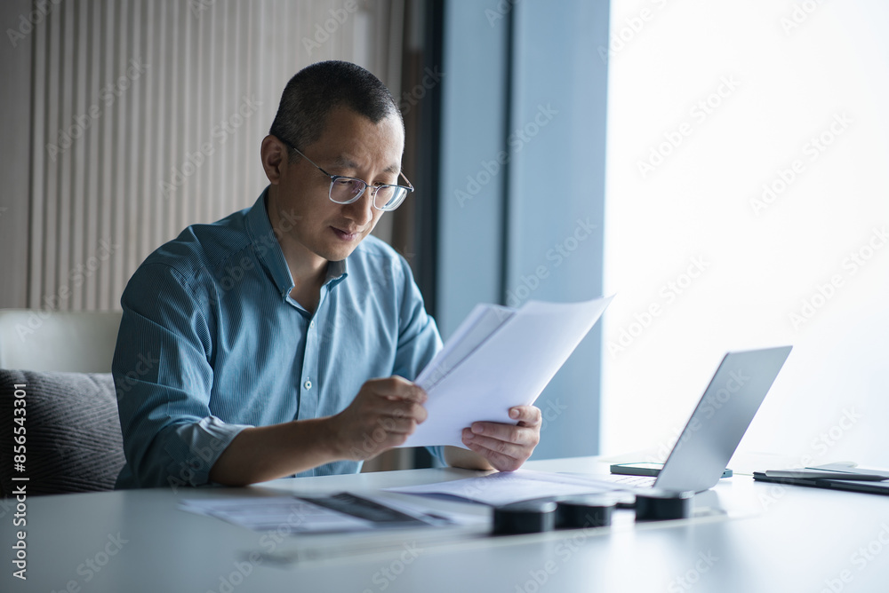 businessman looking document in office businessman looking document in office
