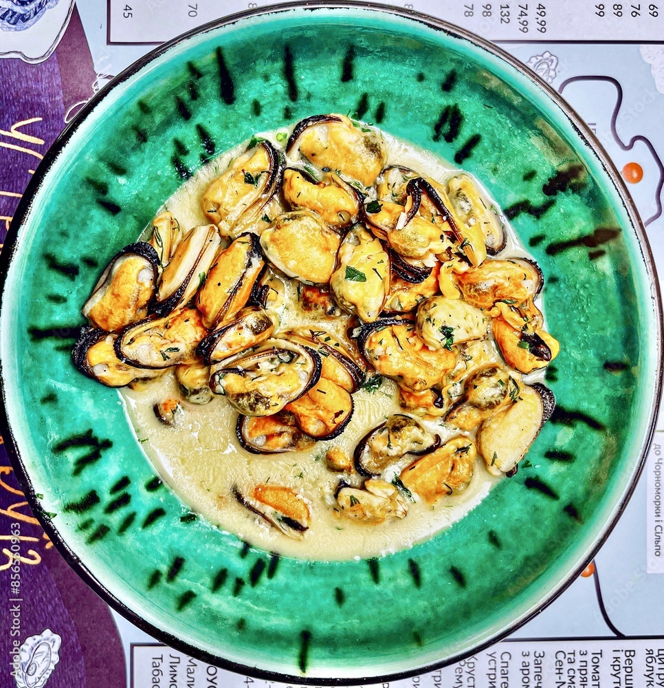 Sea mussels in a plate on a table in a restaurant