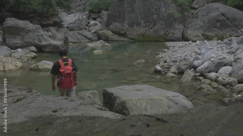 A backpacker admiring the beautiful scenery A backpacker admiring the beautiful scenery